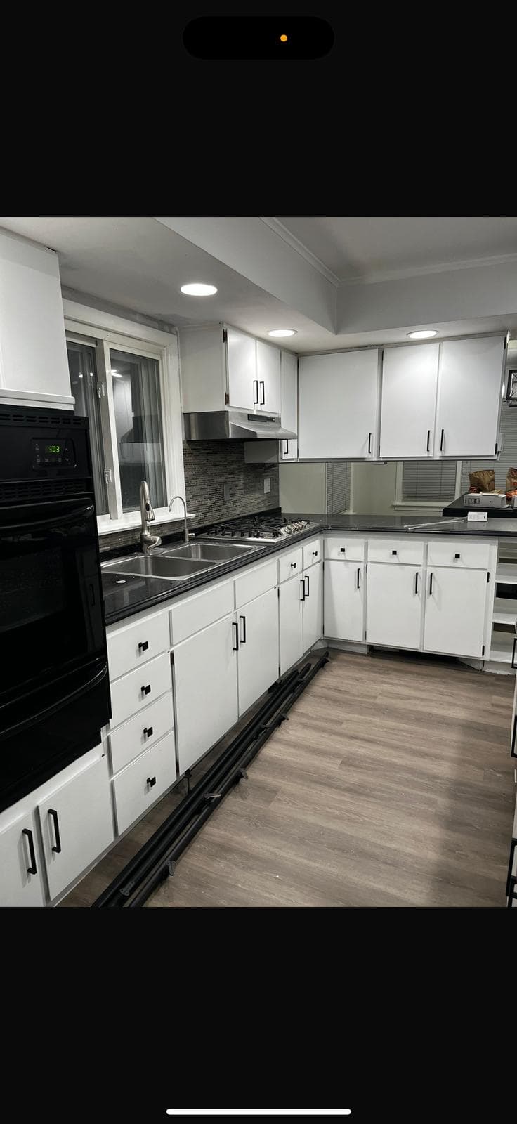 Finished kitchen with modern cabinetry, lighting, and countertops